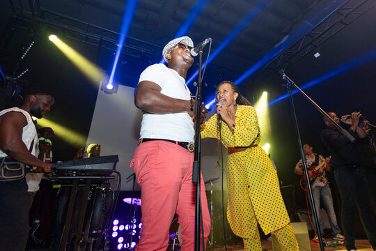 Two singers performing live concert on stage