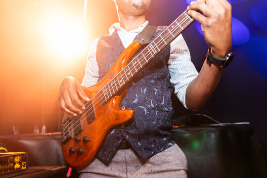 Bass guitarist performing live on stage during concert