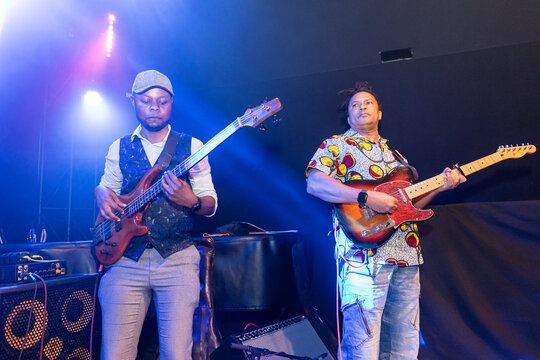 Musicians playing instruments on stage during live music concert