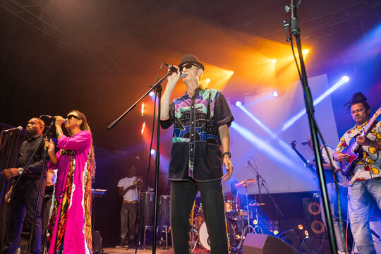 Band performing live concert on illuminated stage