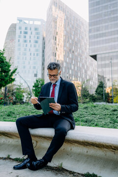 A businessman using a tablet in the city