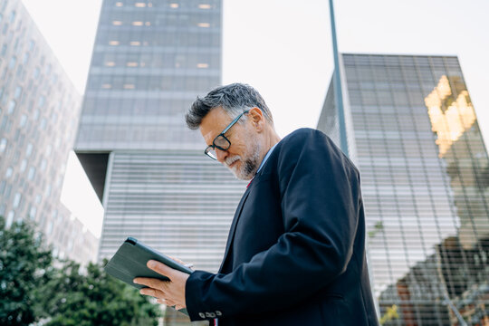A businessman using a tablet in the city