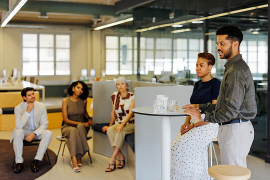 Professionals networking and discussing business in modern office