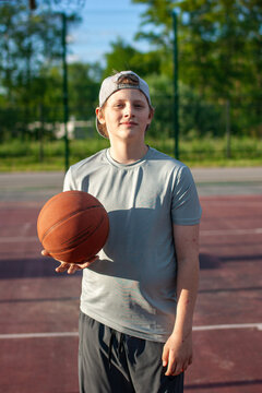 Teen boy portrait with basketball ball