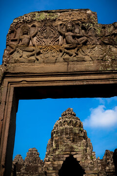 Stone gateway framing the smiling faces of Bayon Temple