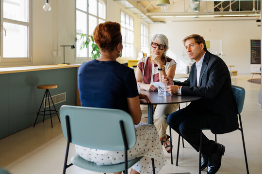 Professionals conducting business interview at modern office