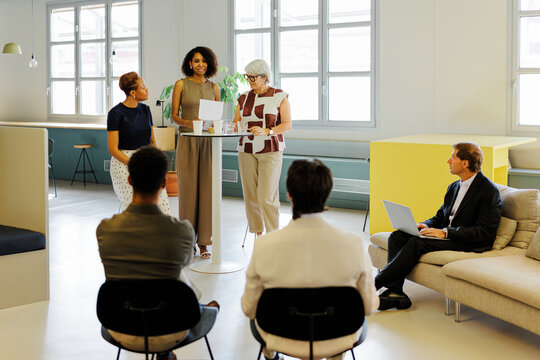 Business professionals collaborating and discussing in modern office