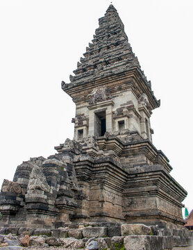 A majestic front view of an ancient Javanese Hindu temple featuring intricate stone carvings, symmetrical architecture, and historic stairways. This iconic cultural heritage landmark showcases the ric