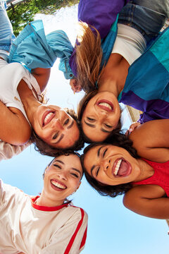 Friends enjoying a sunny day while smiling in a circle