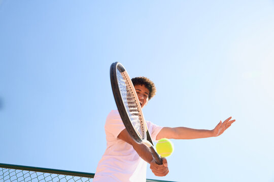 Young Player Hits Tennis Ball During Practice Session Outside