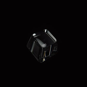 Sleek transparent glass escape keycap isolated on a black background.