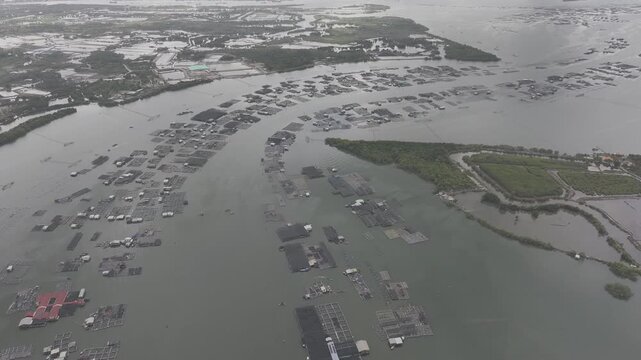 Aerial drone footage of oyster farming in Long Son, Ho Chi Minh City, Vietnam, showcasing traditional aquaculture, floating oyster farms, coastal fishing industry and sustainable seafood production.