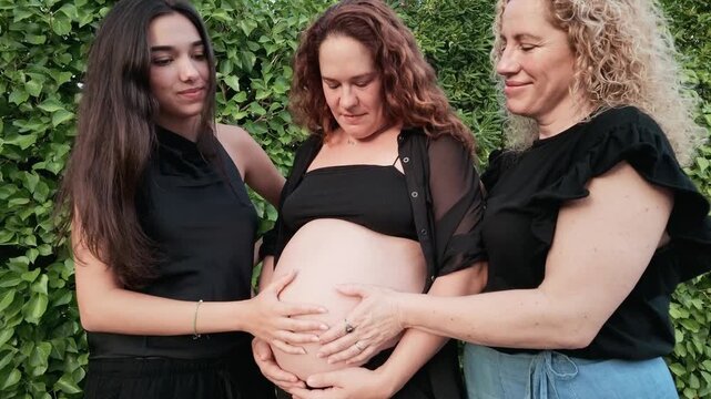 Pregnant woman enjoying quality time with her family and relaxing by the swimming pool in a natural outdoor setting