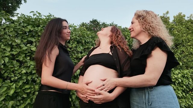 Pregnant woman enjoying quality time with her family and relaxing by the swimming pool in a natural outdoor setting