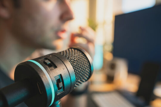 Person speaking into a professional podcast microphone