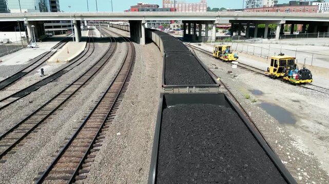 Aerial flyover of train carrying coal in Kansas City railyard