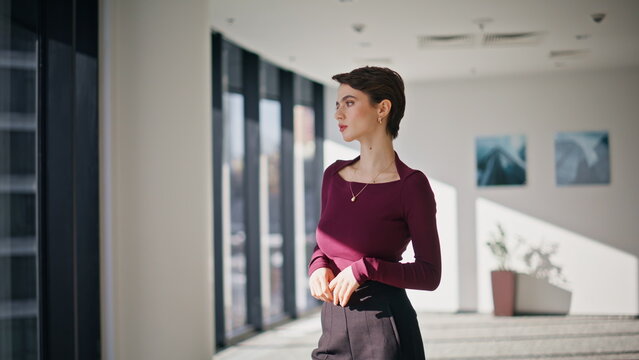Confident businesswoman walking modern office lobby. Young model portrait 