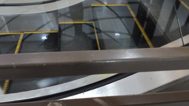 Moving escalator inside a modern shopping mall or commercial building interior