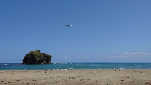 ANA airplane flying over Hakuto Coast with Oki Island and shrine gate in Tottori Japan