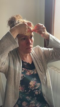 Woman performing face tapping massage as part of a natural skincare routine