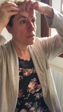 Woman performing face tapping massage as part of a natural skincare routine
