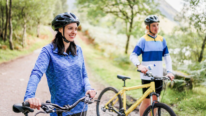 Fototapeta premium Cyclists enjoying scenic forest trail