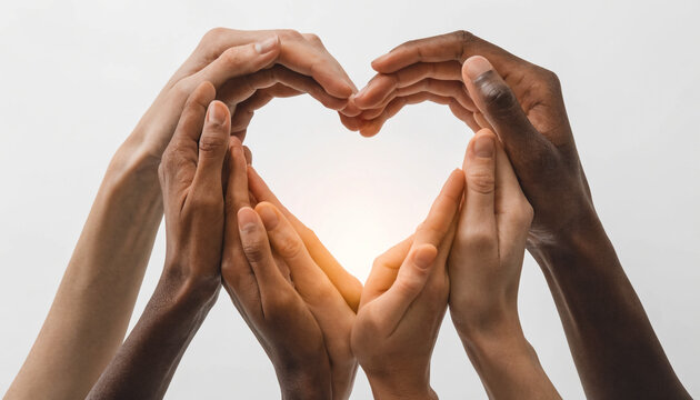 Diverse hands forming a heart shape. People of different races showing unity and love.