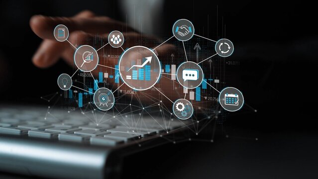Business analytics and technology concept with hands on keyboard and digital interface of graphs, charts, and icons for data analysis in a corporate environment Sigmoid