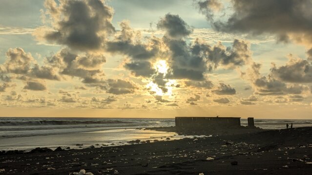 Sunset view over the rocky coastline and ruins near Parangtritis Beach in Yogyakarta, Indonesian