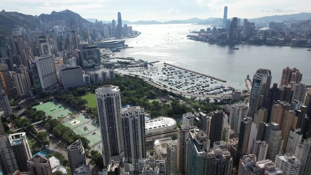 Panoramic high-angle view of Hong Kong city skyline, Victoria Harbour, and Kowloon from Victoria Peak