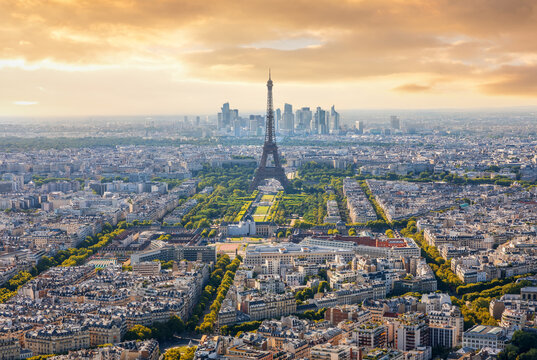 Scenic aerial panorama of Paris cityscape with Eiffel Tower during a vibrant golden hour sunset