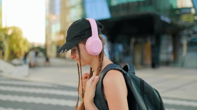 Generation Z, Dedicated schoolgirl holding heavy backpack straps near modern campus buildings.