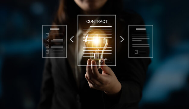 A businesswoman showcases a glowing light bulb representing innovation and creativity while engaging with digital contract documents in a modern office setting. Cyphers