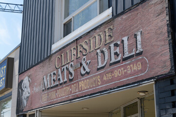 Obraz premium old painted sign on the exterior of Cliffside Meat & Deli, a butcher shop and deli, located at 2476 Kingston Rd, Scarborough, Toronto