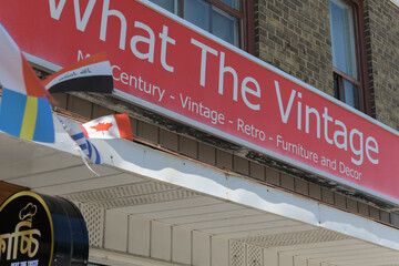 Obraz premium exterior building facade and sign of What The Vintage, a furniture store, located at 2468 Kingston Rd, Scarborough, Toronto
