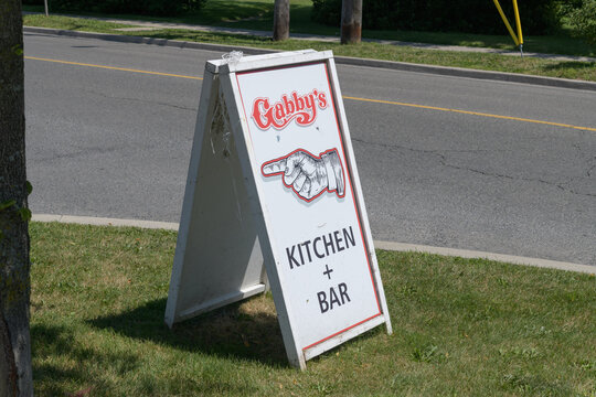 a-frame boulevard or road side sign with manicule near Gabby's, a restaurant chain, located here at 123 Guildwood Pkwy, Scarborough, Toronto
