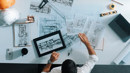 Top view of skilled engineer selecting material for house design while sitting at meeting table...