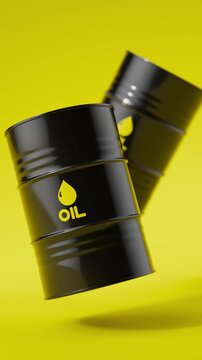 Two black metal oil barrels floating on a yellow background for petroleum industry concept. Vertical video.