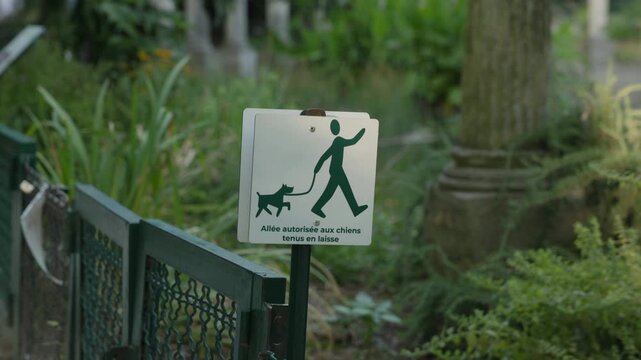 Close Up of a Sign Permitting Dogs on Leash in a European Public Park