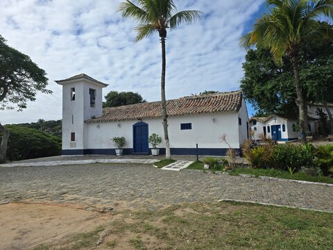 Historic Saint Anne Church (Igreja de Sant'Anna) with colonial white architecture and palm trees in Armacao dos Buzios, Rio de Janeiro, Brazil.