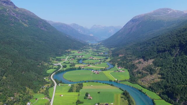 Aerial drone view of a winding river in a mountain valley near Stryn, Norway. Scenic water landscape, high peaks, and popular Scandinavian travel destination.