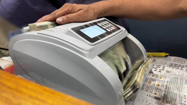 Shot of 500 Indian rupees banknotes in cash counting by machine. Indian cash counting video