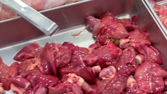 Assortment of fresh raw chicken meat parts displayed at market