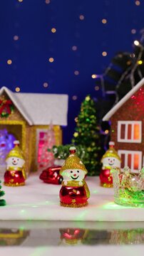 A yellow car drives past a Christmas town and an unusual Santa Claus jumps out