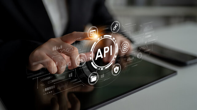 Business professional interacting with digital API interface concept on tablet screen showcasing technology, innovation, data sharing, and connectivity in modern workspace. Entropy.