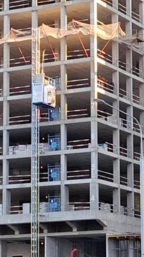 The service elevator takes workers and people outside the building under construction