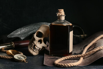 Skull with rum and compass on dark table. Pirate concept © Pixel-Shot