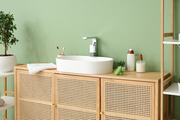 Naklejka na ściany i meble Sink with hair scalp massager and bath accessories in room