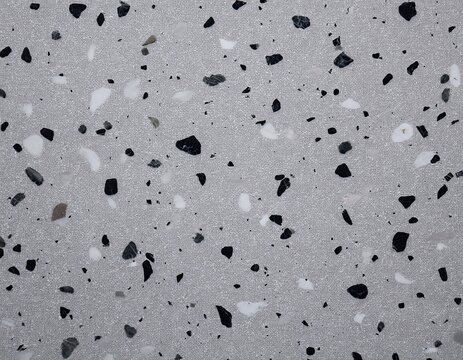 fine grey terrazzo stone with small black speckles background surface texture