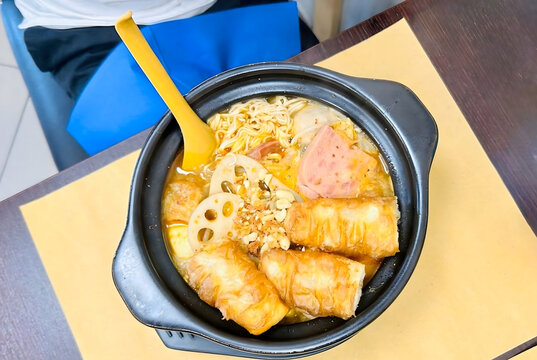 A bowl of Sichuan malatang soup with noodles, vegetables and meat.